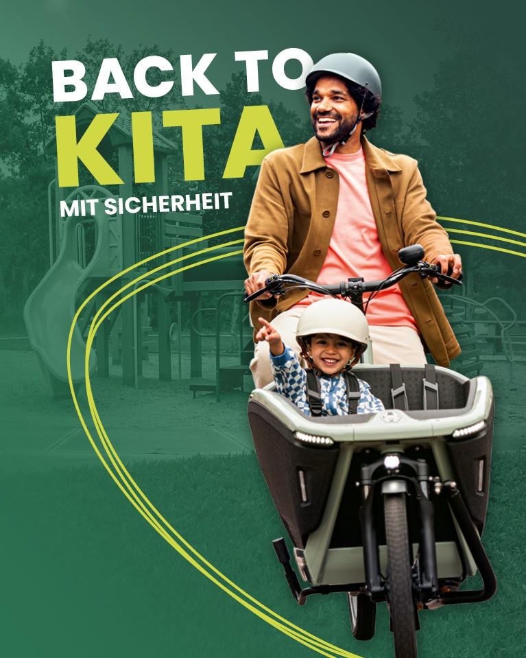 Ein Mann fährt auf dem Lasten e-Bike mit seinem Kind mit Helm in der Transportbox